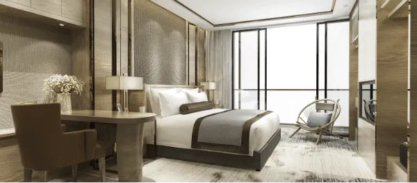 Chambre d'hôtel moderne avec lit et bureau.